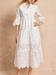 White eyelet tiered midi dress with button front, flared sleeves, and scalloped hem.