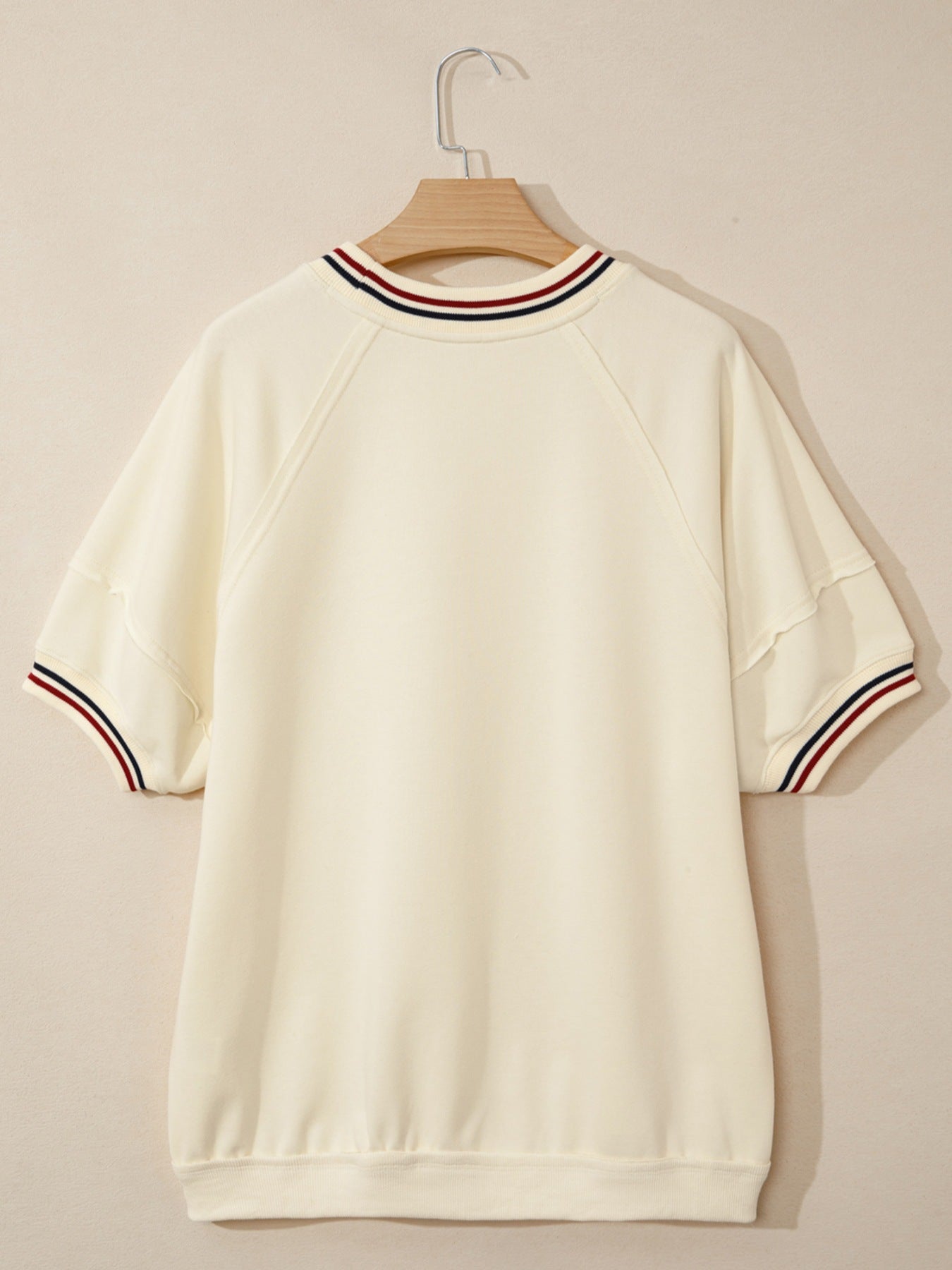 Beige cotton tunic top with striped neckline and sleeve cuffs.