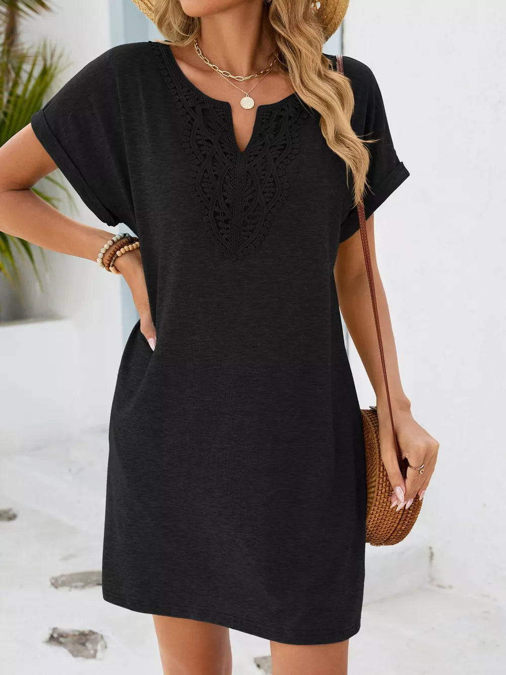 Black lace-trimmed V-neck pocket dress with short sleeves.