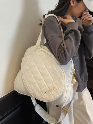 Quilted off-white Oxford bag for racket storage with adjustable strap.