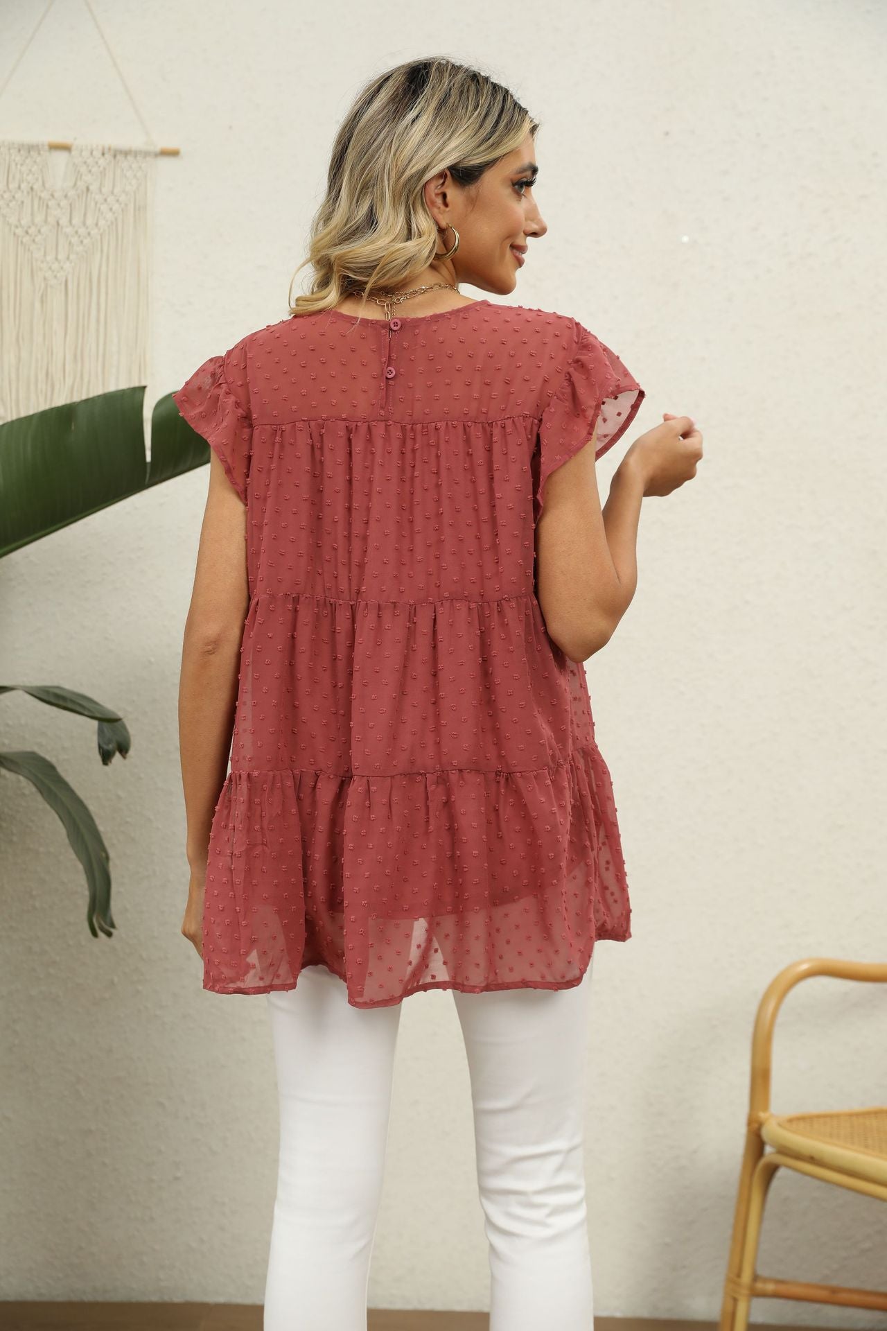Swiss dot flutter sleeve tiered blouse in Brick Red with button back detail.