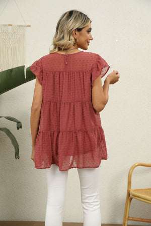 Swiss dot flutter sleeve tiered blouse in Brick Red with button back detail.