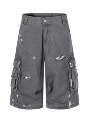 Gray cargo capris with distressed detailing and plaid patches.