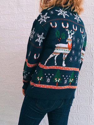 Navy acrylic turtleneck sweater with intarsia reindeer, trees, and snowflakes pattern.