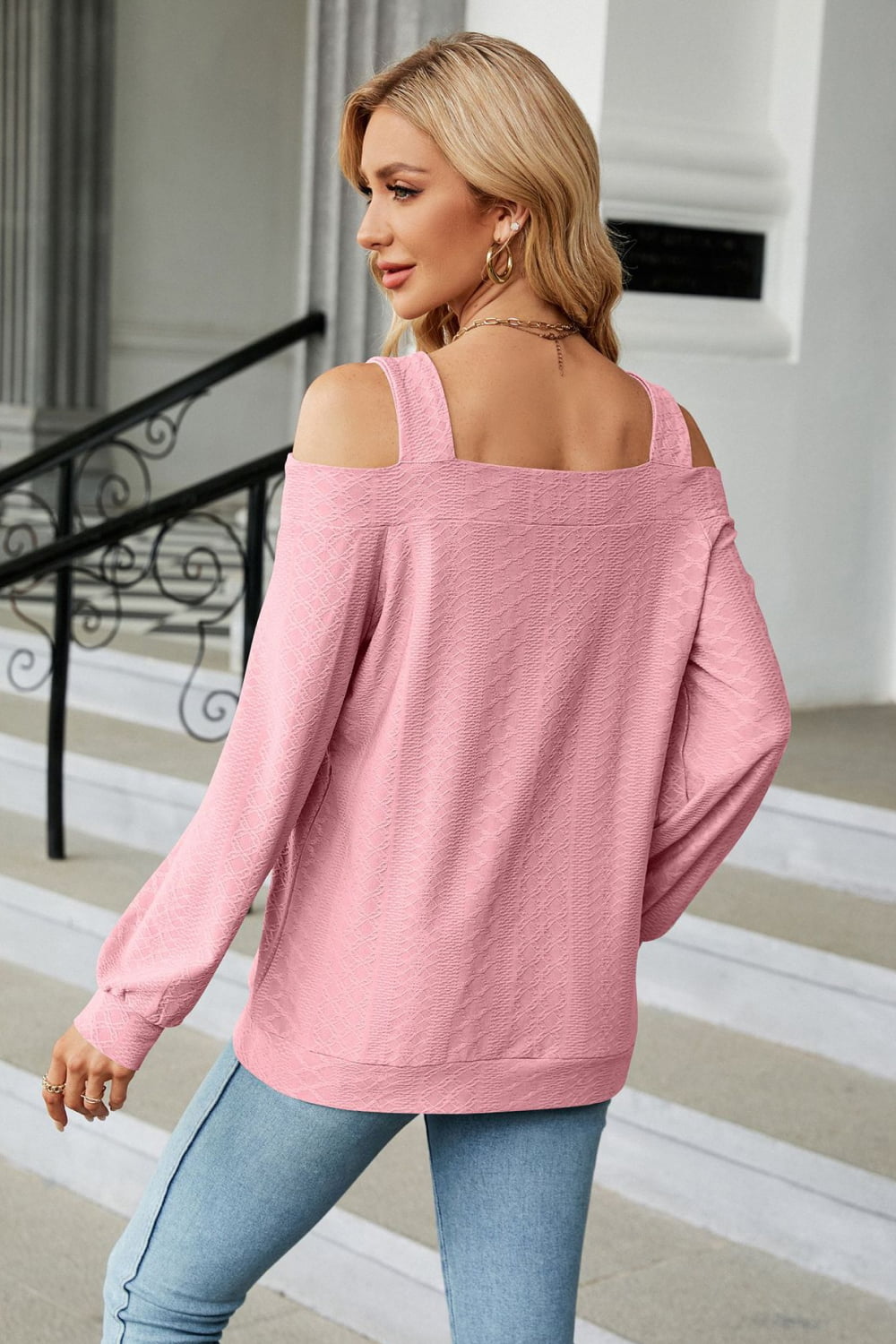 Blush pink textured open shoulder blouse with square neckline and long sleeves.