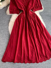 Crimson lace-embellished A-line midi dress with button front and puff sleeves.