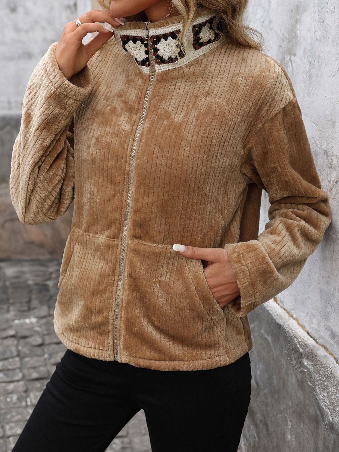 Camel plush corduroy zip-up jacket with crochet collar detail and front pockets.