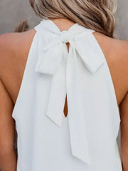 White halterneck tie-back top with keyhole detail and bow closure at the neck.