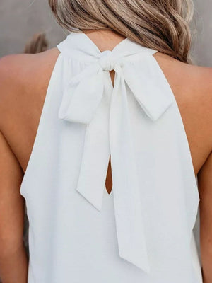 White halterneck tie-back top with keyhole detail and bow closure at the neck.