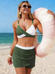 Two-piece dark green and white cami bikini with wrap-style top and skort.