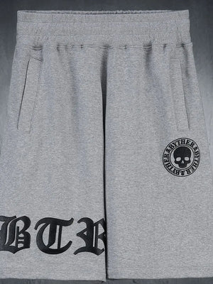 Gray graphic shorts with gothic script and skull logo