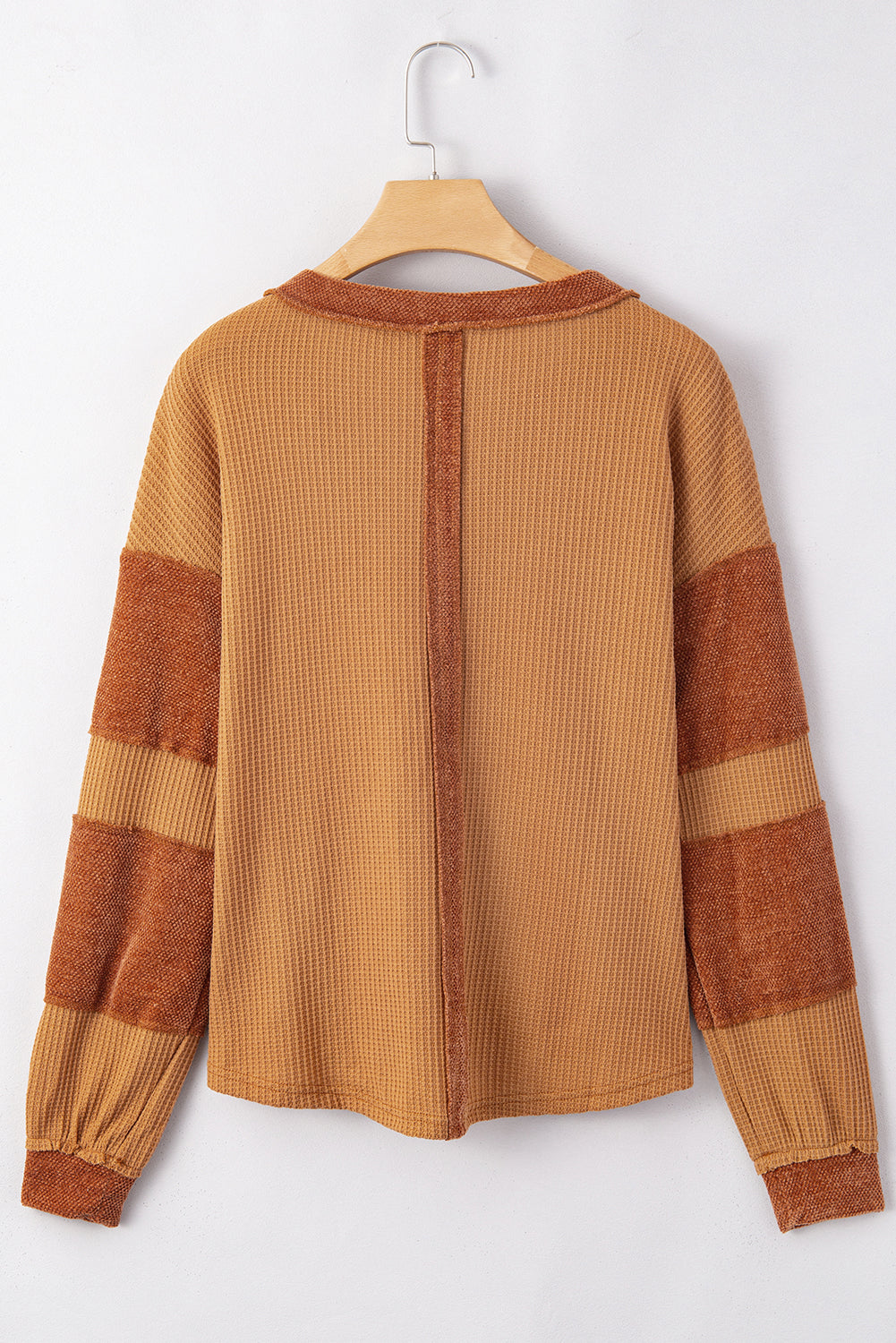 Caramel waffle knit henley top with contrast stitching and striped sleeves.