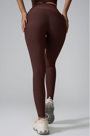 Brown ribbed contour leggings with diagonal seam detail.