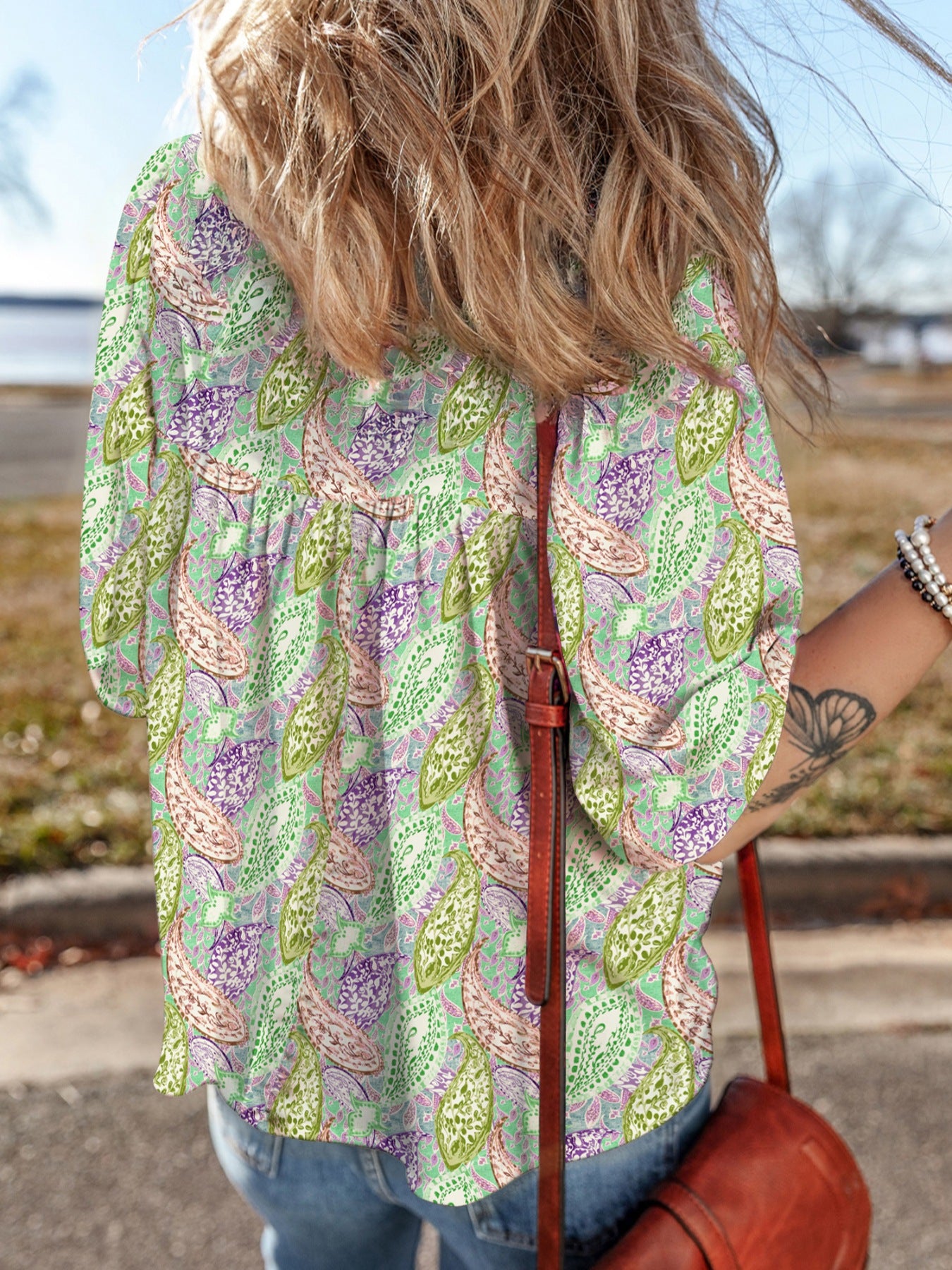 Paisley print puff sleeve blouse in light green with purple and pink accents.