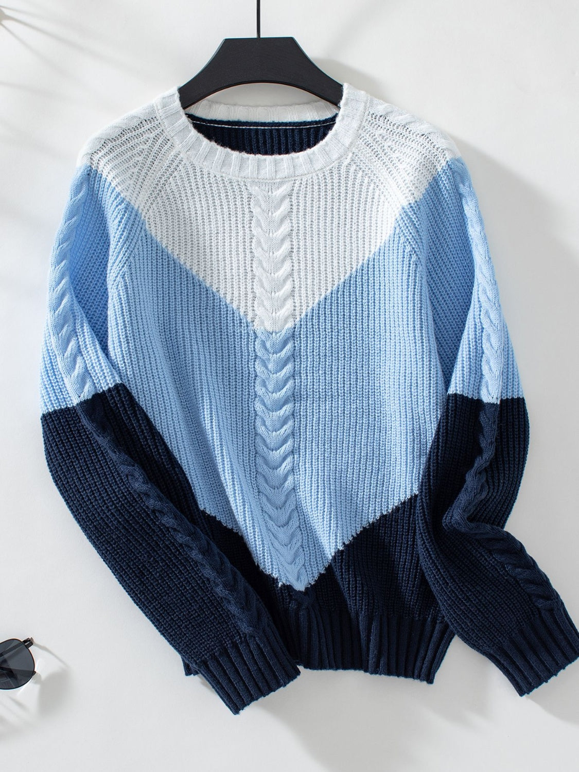 Chevron cable knit sweater in pastel blue and white with navy accents.