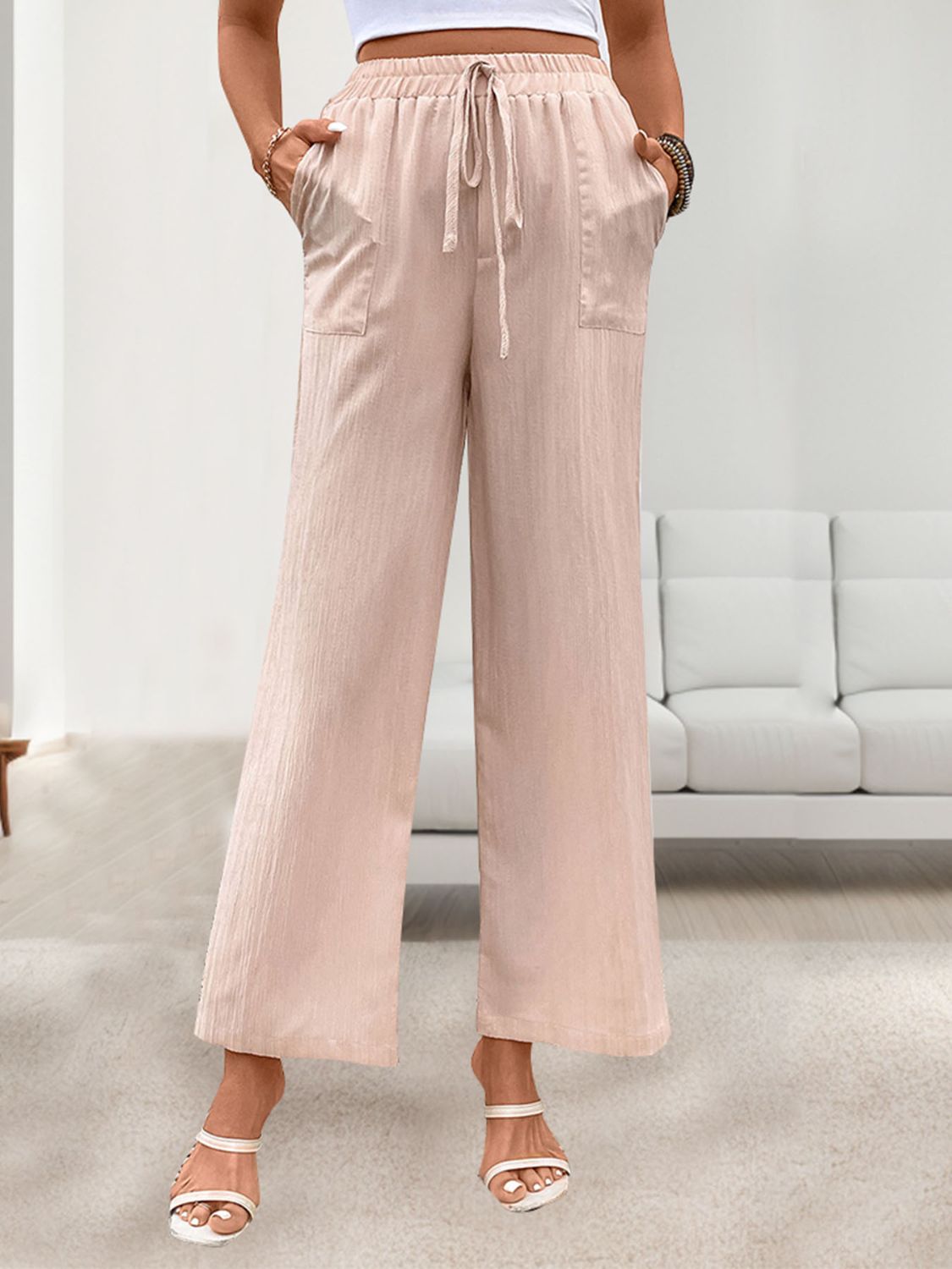 Apricot linen palazzo pants with drawstring waist and side pockets.