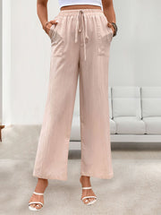 Apricot linen palazzo pants with drawstring waist and side pockets.