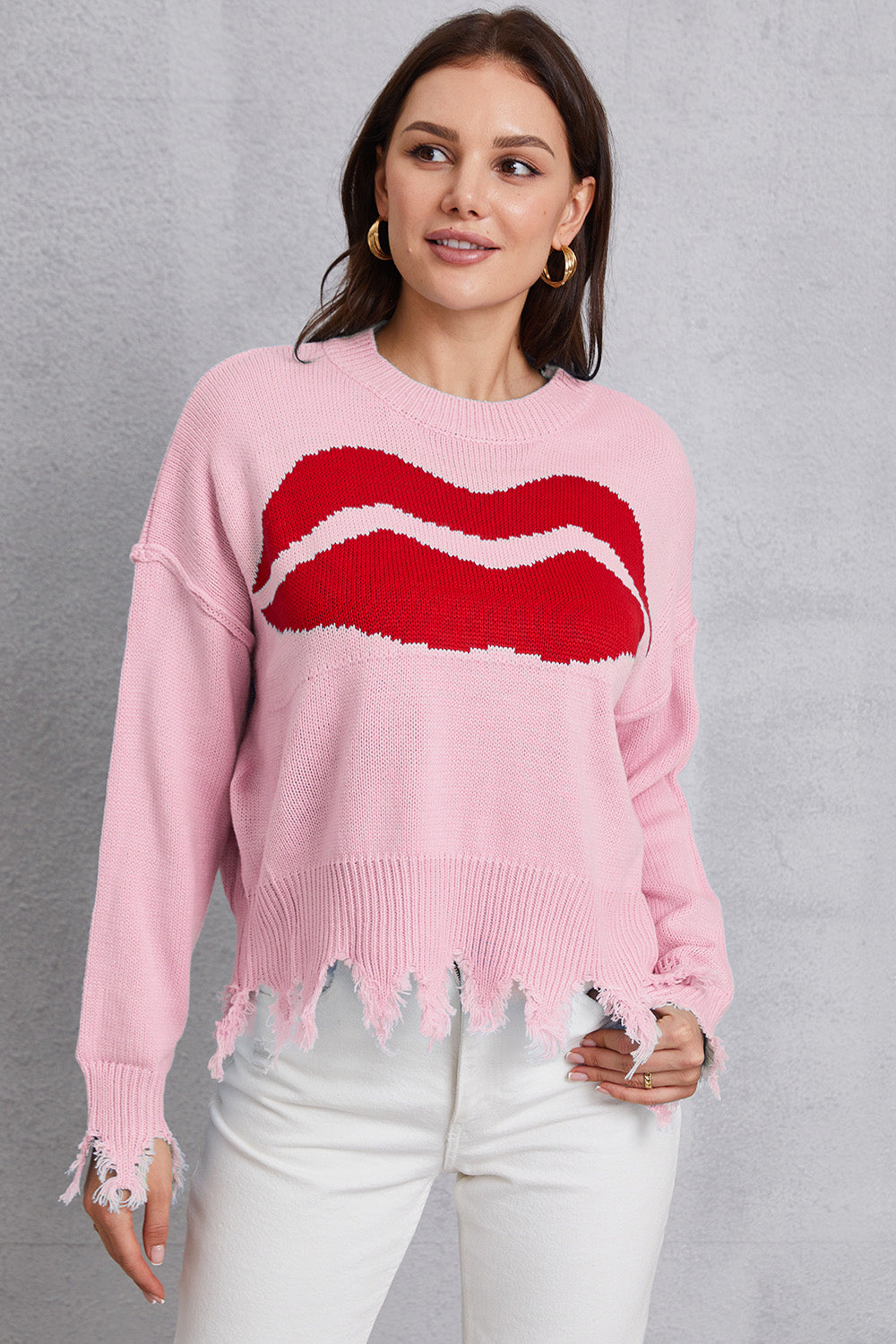 Pink knit sweater with red kiss graphic and distressed hem and cuffs.