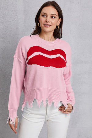Pink knit sweater with red kiss graphic and distressed hem and cuffs.