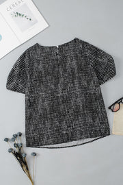 Black dotted puff sleeve blouse with crew neck and short sleeves.