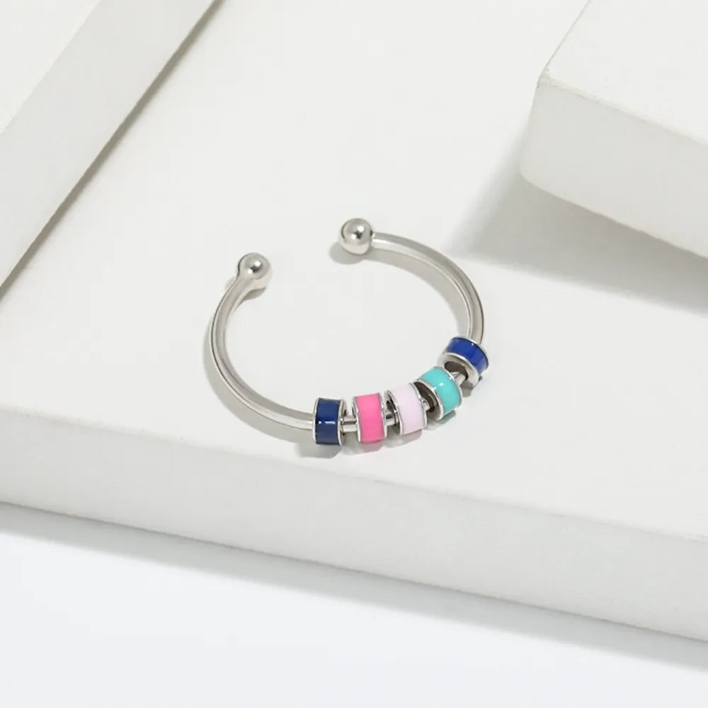 Open-band ring with colorful beads in navy, pink, light pink, light blue, and teal on sterling silver.