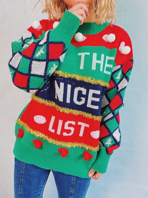 Green crewneck sweater with "The Nice List" graphic, argyle sleeves, and pom-pom details.