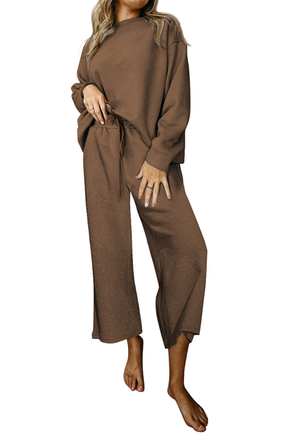 Brown loungewear set with textured pattern, crew neck, drop sleeves, and wide-leg pants with drawstring waist.