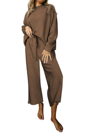 Brown loungewear set with textured pattern, crew neck, drop sleeves, and wide-leg pants with drawstring waist.