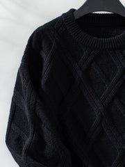 Black diamond cable knit crewneck sweater with ribbed neckline and cuffs.
