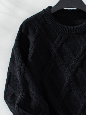 Black diamond cable knit crewneck sweater with ribbed neckline and cuffs.