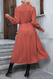 Tiered midi shirt dress in red orange with button cuffs and tie waist.