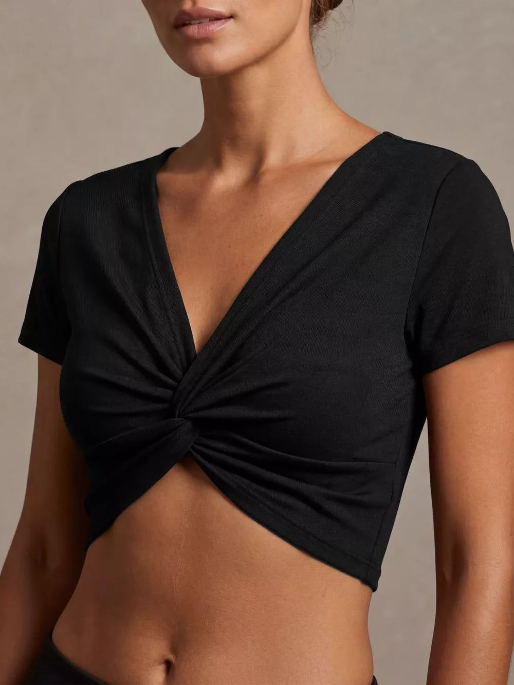 Black ribbed cropped t-shirt with V-neck and front twist detail