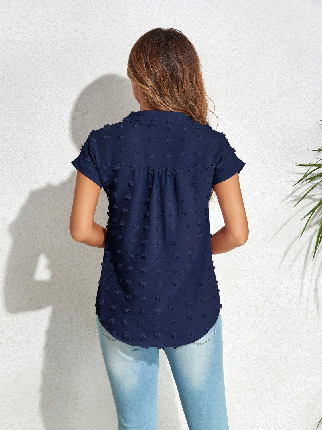 Dark blue textured dot poplin shirt with short sleeves and a collared neckline.