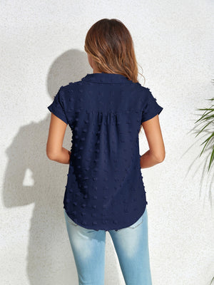 Dark blue textured dot poplin shirt with short sleeves and a collared neckline.