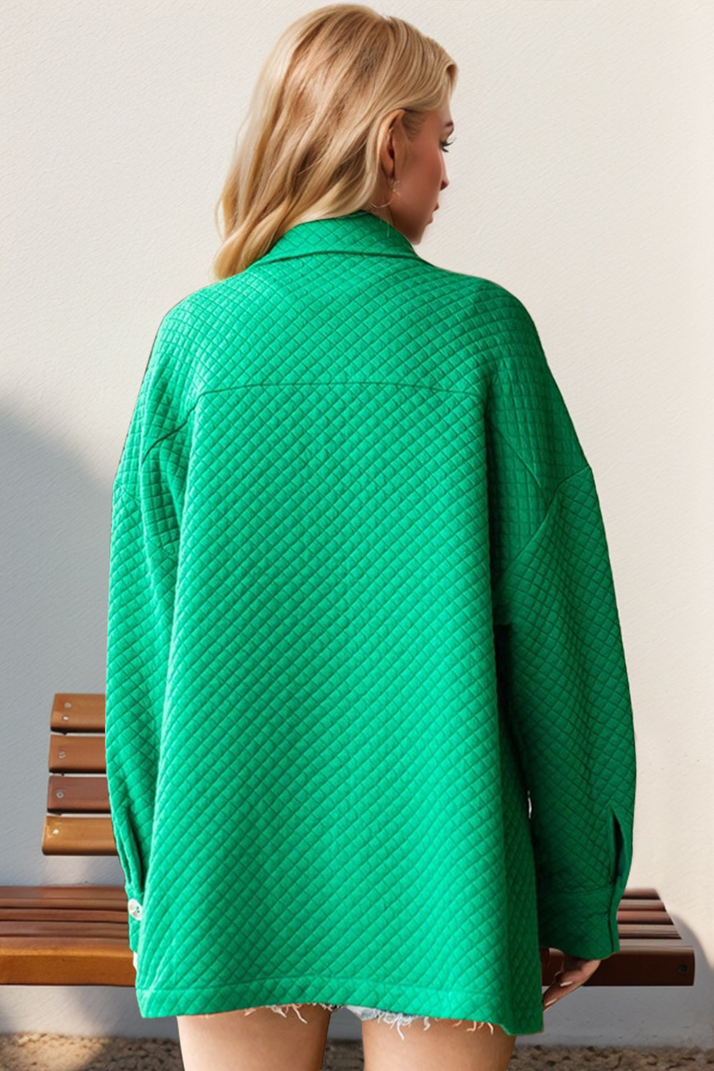 Green diamond quilted oversized shirt jacket with collar and long sleeves.