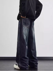 Distressed dark wash wide leg men's jeans with a relaxed fit and visible pocket details.