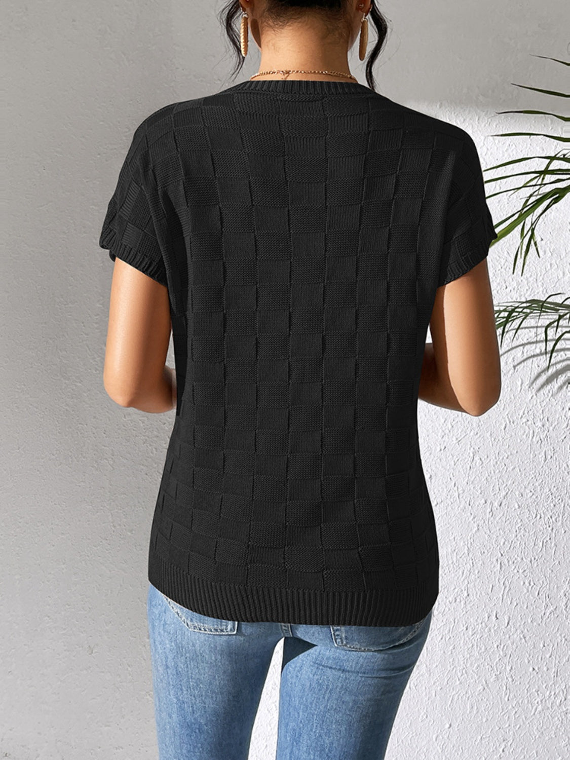 Black textured knit pocket tee with short sleeves and a crew neck.