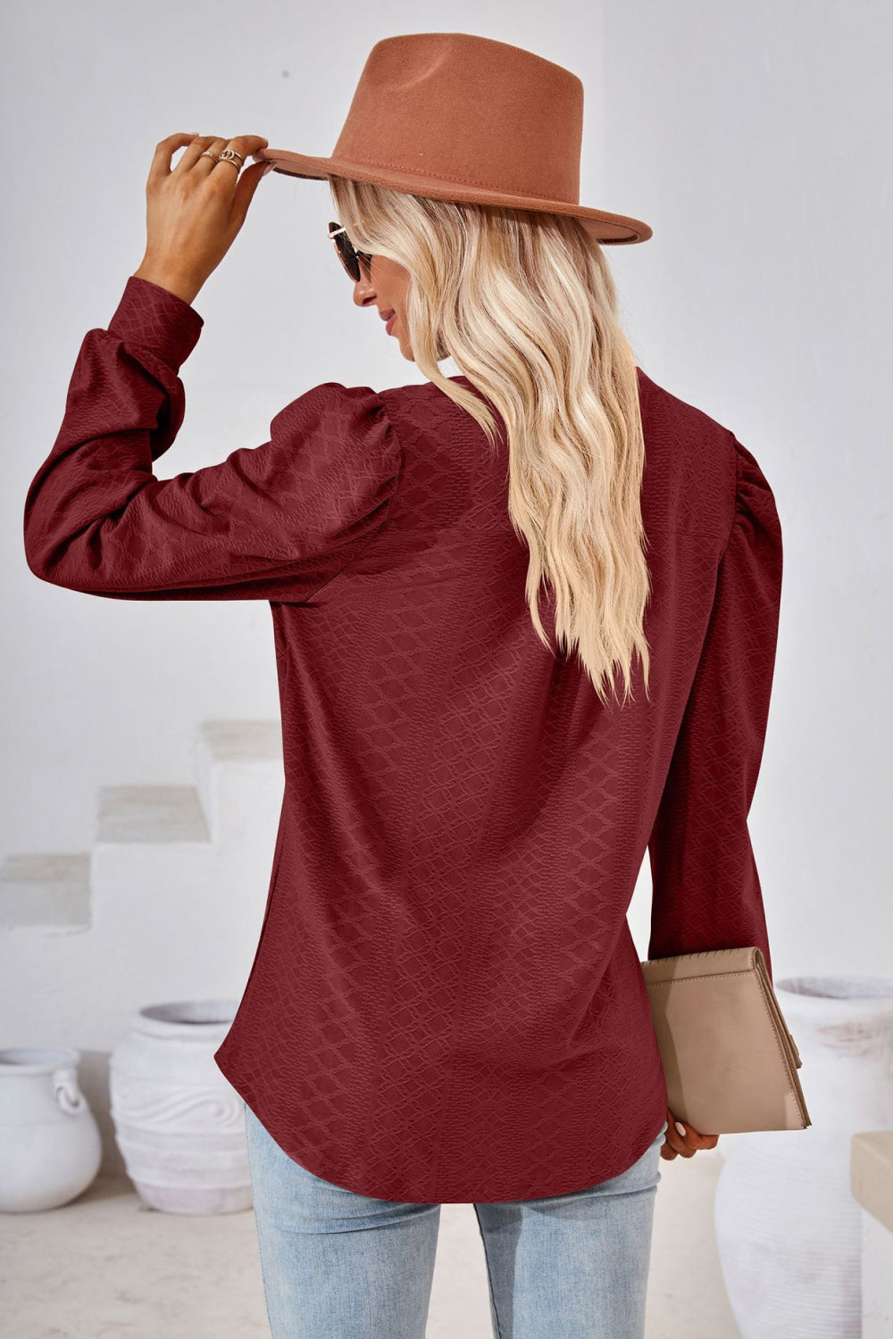 Burgundy textured blouse with bishop sleeves and a subtle diamond pattern.