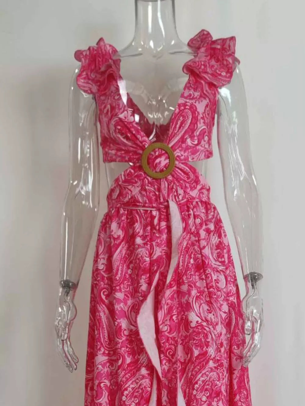 Pink paisley ruffled V-neck maxi dress with cut-outs and a wooden ring detail.