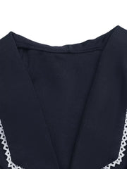 Navy lace-trimmed tie-front vest with V-neckline.