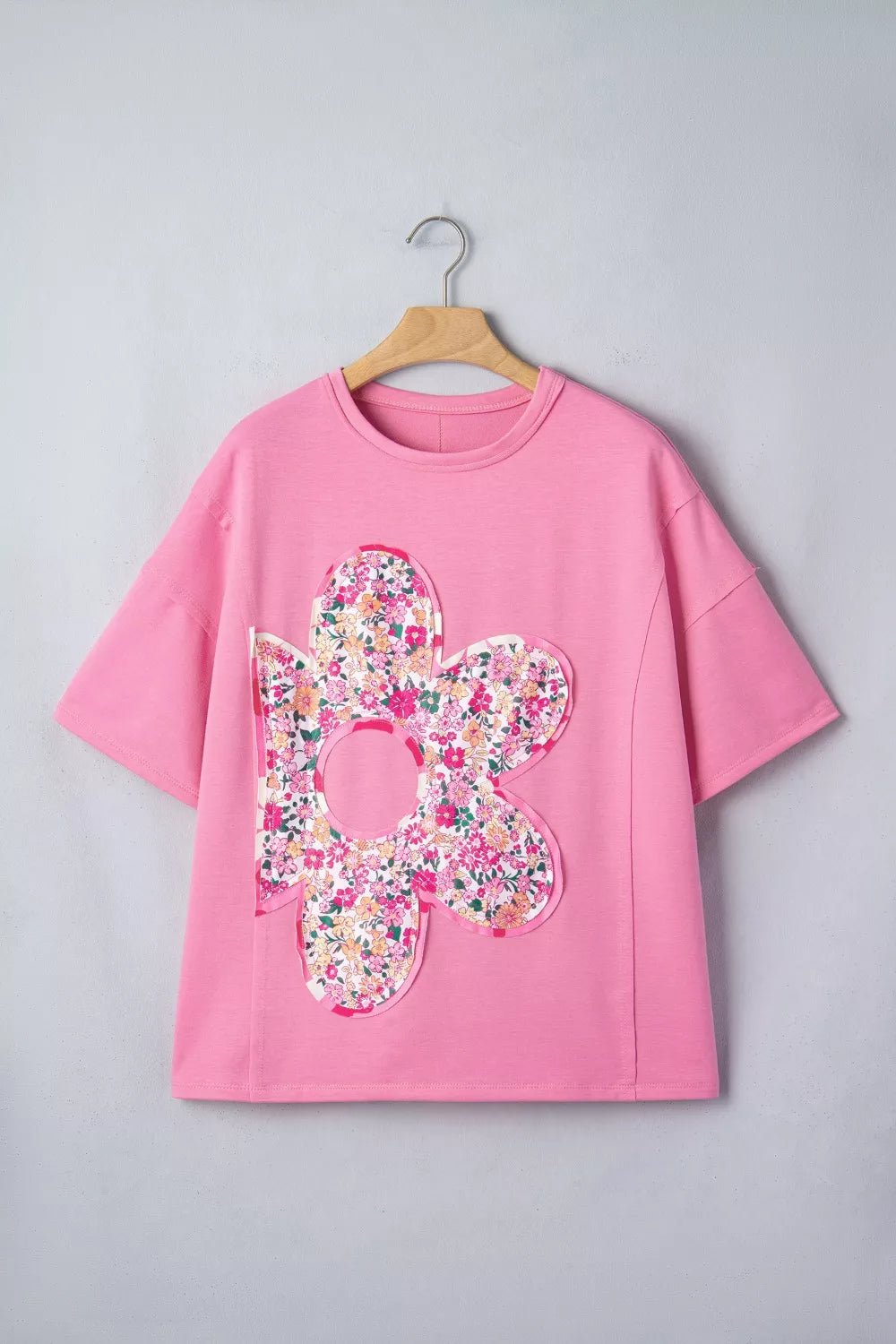 Pink cotton oversized tunic t-shirt with a large floral patch detail.