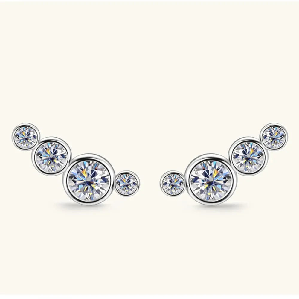 Silver ear climbers with five round, sparkling crystals in a graduated cluster design.