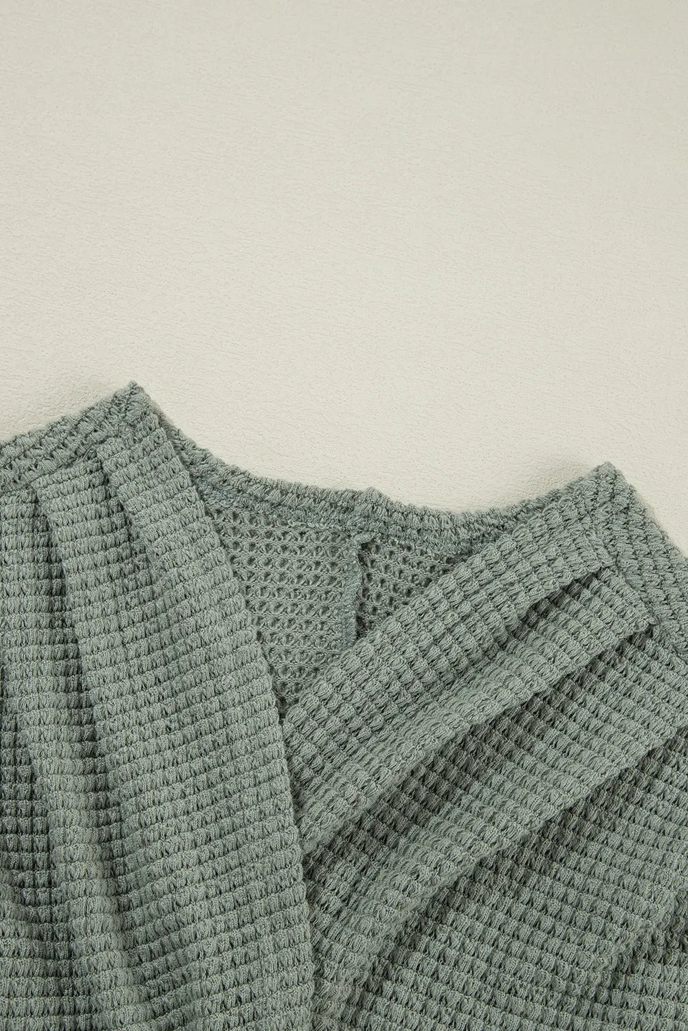 Sage waffle knit open-front duster cardigan with textured fabric detail.