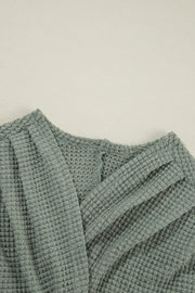 Sage waffle knit open-front duster cardigan with textured fabric detail.