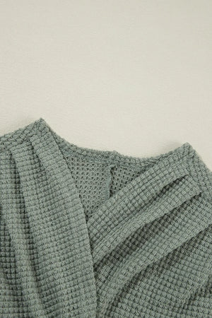 Sage waffle knit open-front duster cardigan with textured fabric detail.