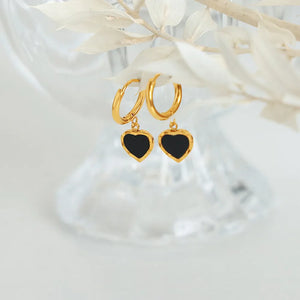 Gold hoop earrings with black enamel heart charms