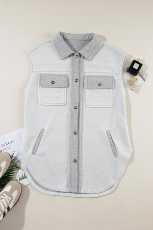 Light gray cotton utility vest with contrast trim, button-down front, and chest pockets.