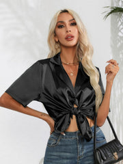Black satin tie-front collared shirt with short sleeves and button detail
