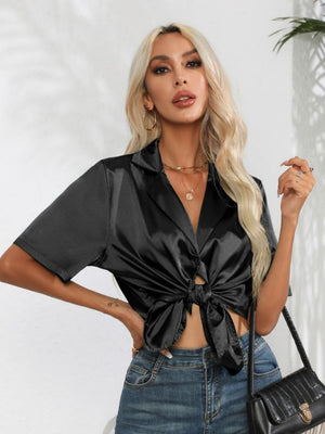 Black satin tie-front collared shirt with short sleeves and button detail