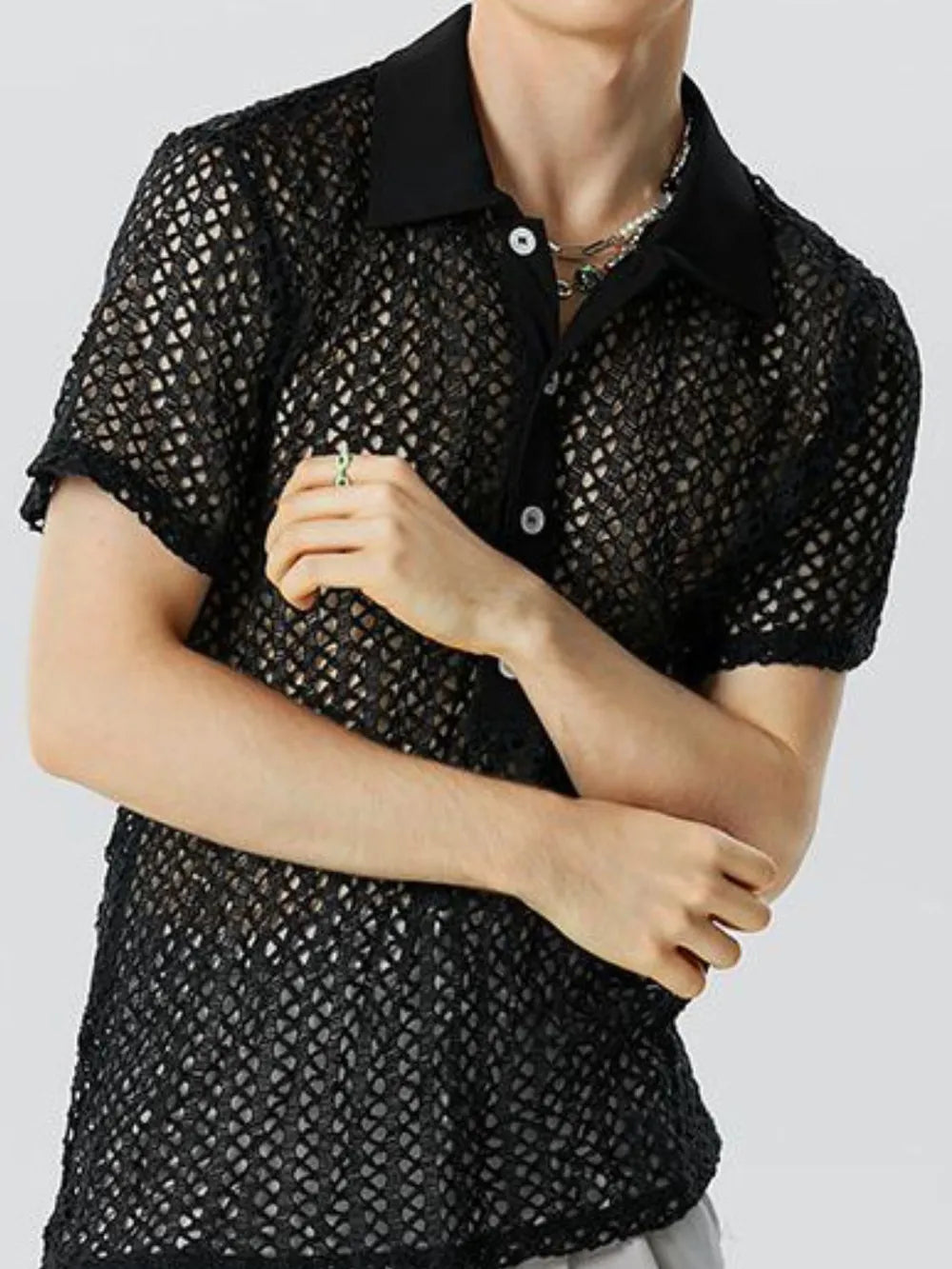 Black openwork mesh polo shirt with short sleeves and a button-up collar.